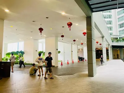 a group of people standing in a building with red lanterns at Regalia SkyLux Studio in Kuala Lumpur