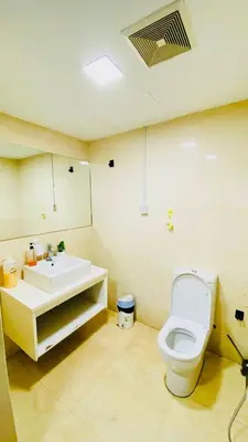 a bathroom with a toilet and a sink at RegaliaA Residences in Kuala Lumpur