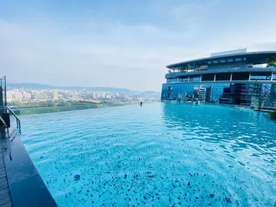a large pool of water in front of a building at The MANOR INFINITY Suites KLCC in Kuala Lumpur