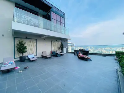 a person sitting on the roof of a building at The MANOR INFINITY Suites KLCC in Kuala Lumpur