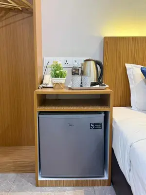 a room with a bed and a table with a tv at Astarr Hotel KL in Kuala Lumpur