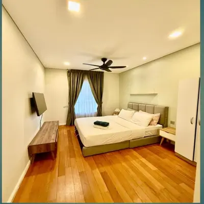 a bedroom with a bed and a ceiling fan at KLCC Sky suites apartment bukit bintang in Kuala Lumpur