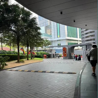 a woman walking down a sidewalk in a building at KLCC Sky suites apartment bukit bintang in Kuala Lumpur