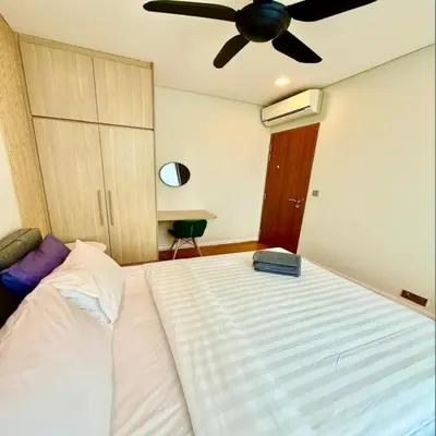 a bedroom with a large bed with a ceiling fan at KLCC Sky suites apartment bukit bintang in Kuala Lumpur