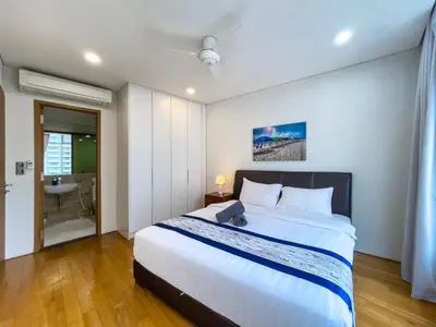 a bedroom with a large bed and a bathroom at VORTEX SUITES KLCC By HOMESTAY in Kuala Lumpur