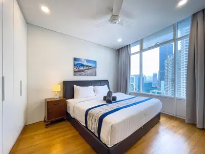 a bedroom with a large bed and a large window at VORTEX SUITES KLCC By HOMESTAY in Kuala Lumpur