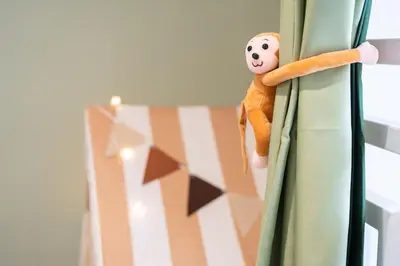 a toy monkey is hanging on a curtain at 9pax, Slide, RockClimbing, Arcade, near City & MITEC in Kuala Lumpur