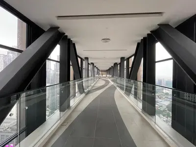 a glass walkway at the top of a building at IKON SUITE's A X O N BUKIT BINTANG in Kuala Lumpur