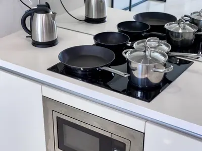 a group of pots and pans on a stove in a kitchen at SOHO SUITES KLCC BY Homestay in Kuala Lumpur