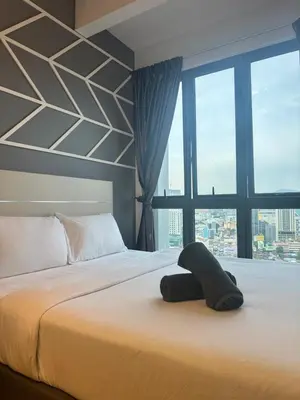 a hotel room with a bed with a large window at The Colony Infinitum KLCC Suits By Saidul in Kuala Lumpur