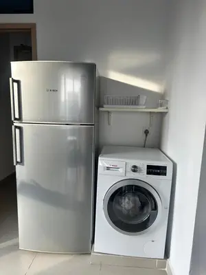 a refrigerator and a washing machine in a kitchen at The Colony Infinitum KLCC Suits By Saidul in Kuala Lumpur