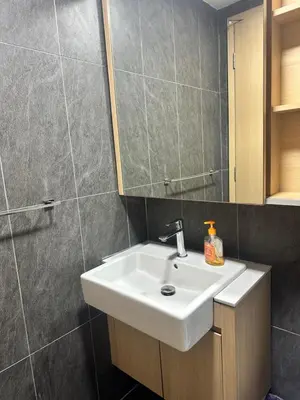 a bathroom with a white sink and a mirror at The Colony Infinitum KLCC Suits By Saidul in Kuala Lumpur