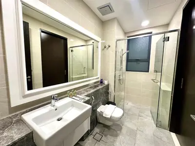 a bathroom with a sink and a toilet and a mirror at KLCC City View luxury Suites in Kuala Lumpur