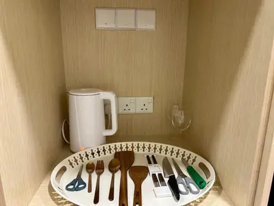 a bunch of utensils on a shelf in a kitchen at KLCC City View luxury Suites in Kuala Lumpur