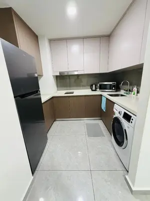 a kitchen with a washer and a dishwasher at Agile Bukit Bintang TRX By Empire Suites in Kuala Lumpur