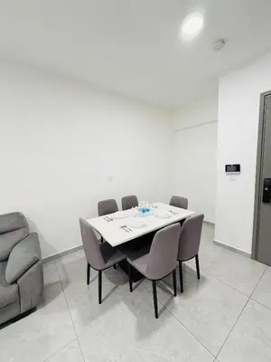 a dining room with a table and chairs and a couch at Agile Bukit Bintang TRX By Empire Suites in Kuala Lumpur