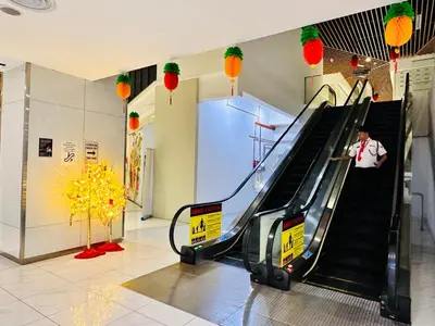 a man riding an escalator in a mall at The Luxe Colony KLCC By KUALA LUMPUR in Kuala Lumpur