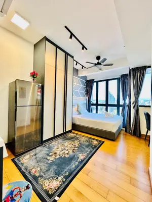 a bedroom with a bed and a refrigerator at The Luxe Colony KLCC By KUALA LUMPUR in Kuala Lumpur