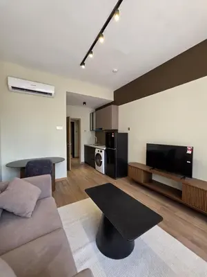 a living room with a couch and a table at Sky Line Suites KL Podu in Kuala Lumpur
