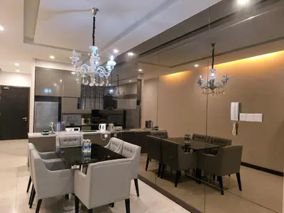 a dining room with chandeliers and a table and chairs at The Dorsett Bukit Bintang KL in Kuala Lumpur