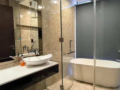 a bathroom with a glass shower and a sink and a tub at The Dorsett Bukit Bintang KL in Kuala Lumpur