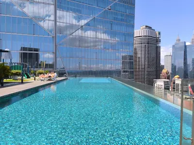 a large swimming pool on the roof of a building at The Dorsett Bukit Bintang KL in Kuala Lumpur