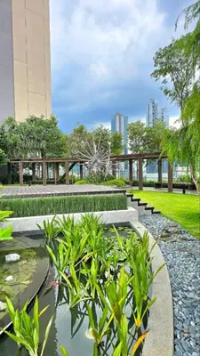 a park with a pond and benches and buildings at Kuala Lumpur Services Apartments In A X O N Residence in Kuala Lumpur