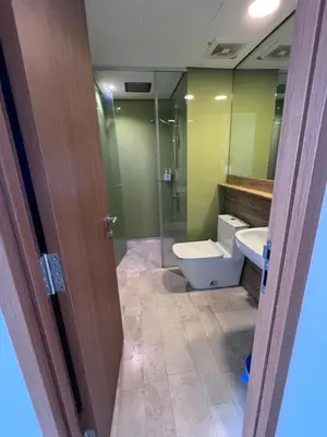 a bathroom with a toilet and a sink and a shower at Sky suites klcc Family suites home in Kuala Lumpur