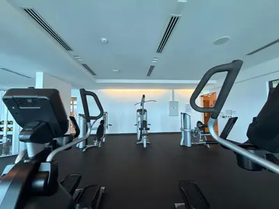 a gym with several treadmills and cardio machines at IKON SUITE's E A T O N KLCC in Kuala Lumpur