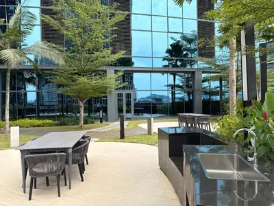 a patio with a table and chairs and a building at IKON SUITE's E A T O N KLCC in Kuala Lumpur