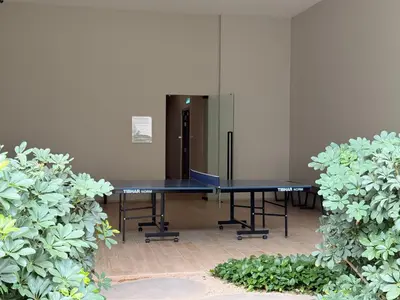 two ping pong tables in a room with plants at IKON SUITE's E A T O N KLCC in Kuala Lumpur
