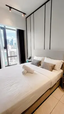 a large bed in a room with a large window at Axon premier suites, Near pavilion Bukit bingtang Kuala Lumpur in Kuala Lumpur