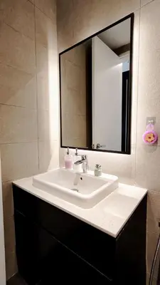 a bathroom with a white sink and a mirror at Axon premier suites, Near pavilion Bukit bingtang Kuala Lumpur in Kuala Lumpur