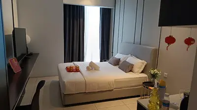 a bedroom with a white bed with a window at Axon premier suites, Near pavilion Bukit bingtang Kuala Lumpur in Kuala Lumpur