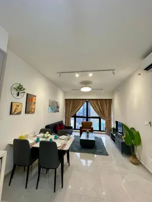 a living room with a table and a couch at Bukit Bintang Service Apartment in Kuala Lumpur