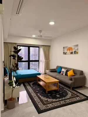 a living room with a couch and a table at Bukit Bintang Service Apartment in Kuala Lumpur
