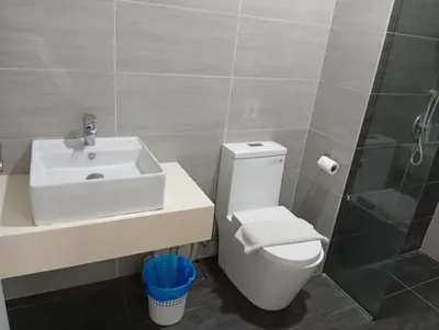 a bathroom with a toilet and a sink and a shower at Family Suites at TRION KL in Kuala Lumpur