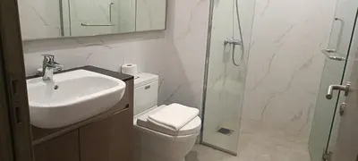 a bathroom with a toilet and a sink and a shower at Family Suites at TRION KL in Kuala Lumpur