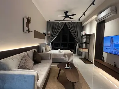 a living room with a couch and a bed at Majestic Residence at KLCC By Fortune in Kuala Lumpur