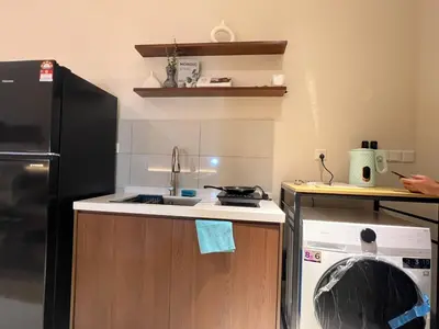 a small kitchen with a sink and a refrigerator at Majestic Residence at KLCC By Fortune in Kuala Lumpur