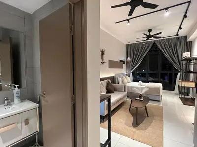 a living room with a couch and a table at Majestic Residence at KLCC By Fortune in Kuala Lumpur