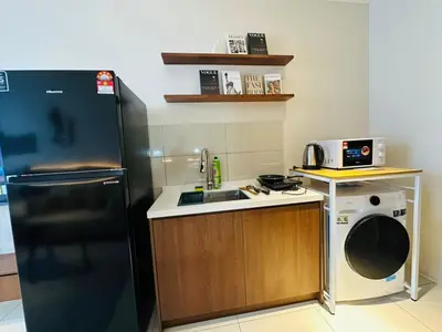 a kitchen with a black refrigerator and a sink at Majestic Residence at KLCC By Fortune in Kuala Lumpur