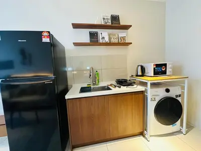 a small kitchen with a sink and a refrigerator at Majestic Residence at KLCC By Fortune in Kuala Lumpur