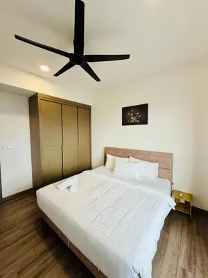 a bedroom with a large bed with a ceiling fan at Agile Bukit Bintang TRX By RUP Suites in Kuala Lumpur