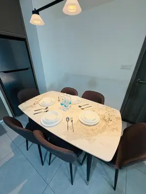 a dining room table with plates and utensils on it at Agile Bukit Bintang TRX By RUP Suites in Kuala Lumpur