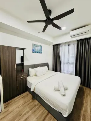 a bedroom with a bed with a ceiling fan at Agile Bukit Bintang TRX By RUP Suites in Kuala Lumpur