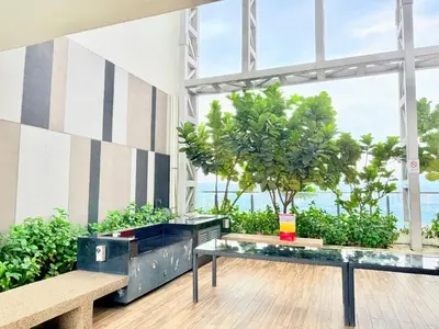 a room with benches and a tree in a building at The luxe by Kuala Lampur City in Kuala Lumpur