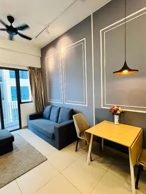 a living room with a blue couch and a table at Sky property by klcc in Kuala Lumpur