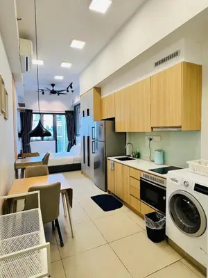 a kitchen with a table and a dining room at Sky property by klcc in Kuala Lumpur