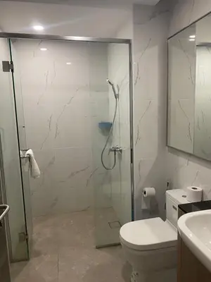 a bathroom with a glass shower and a toilet at agile residence in Kuala Lumpur